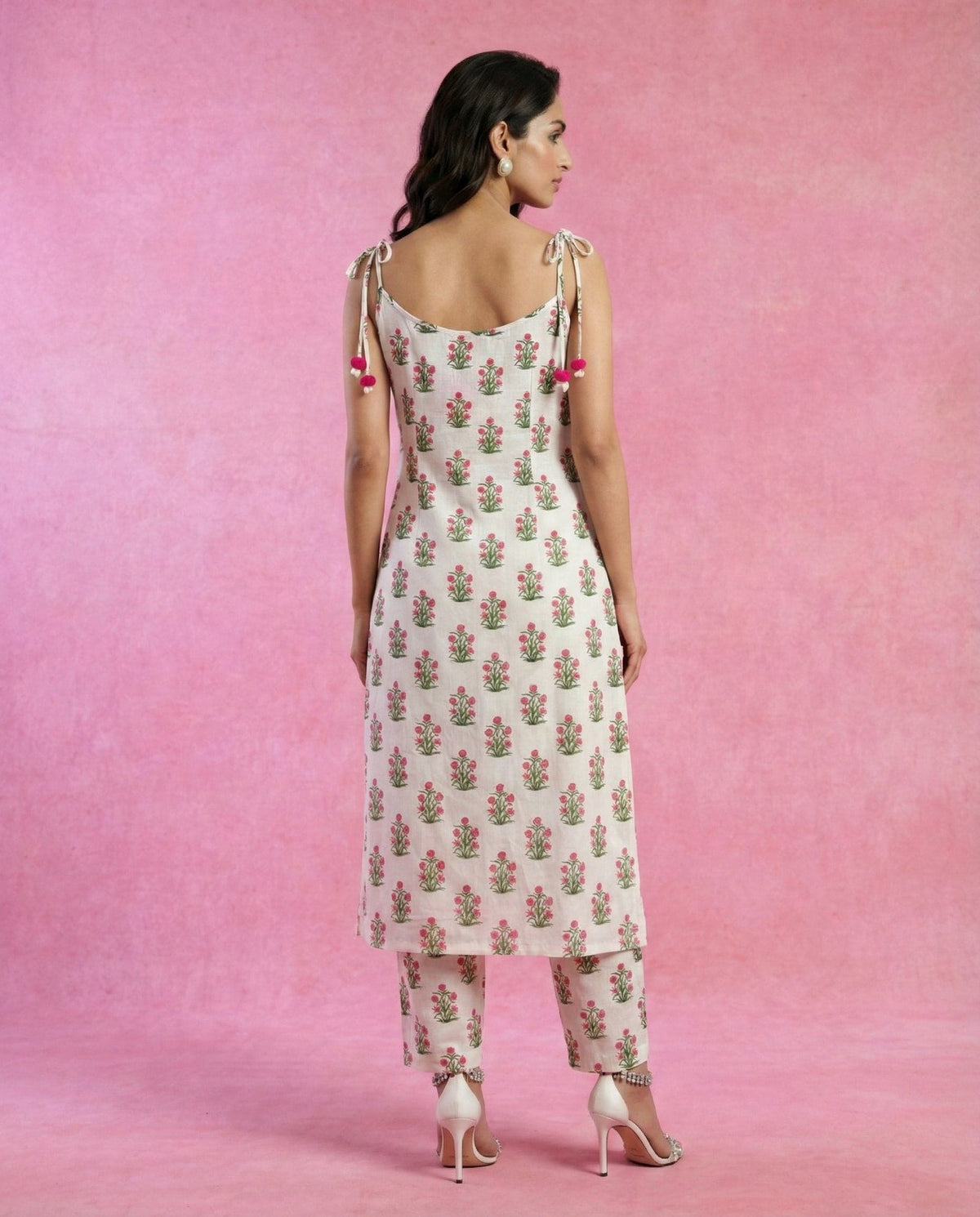 HOOR white cotton kurta with tie-up straps and pom-pom tassels by Neha Sharma Label.