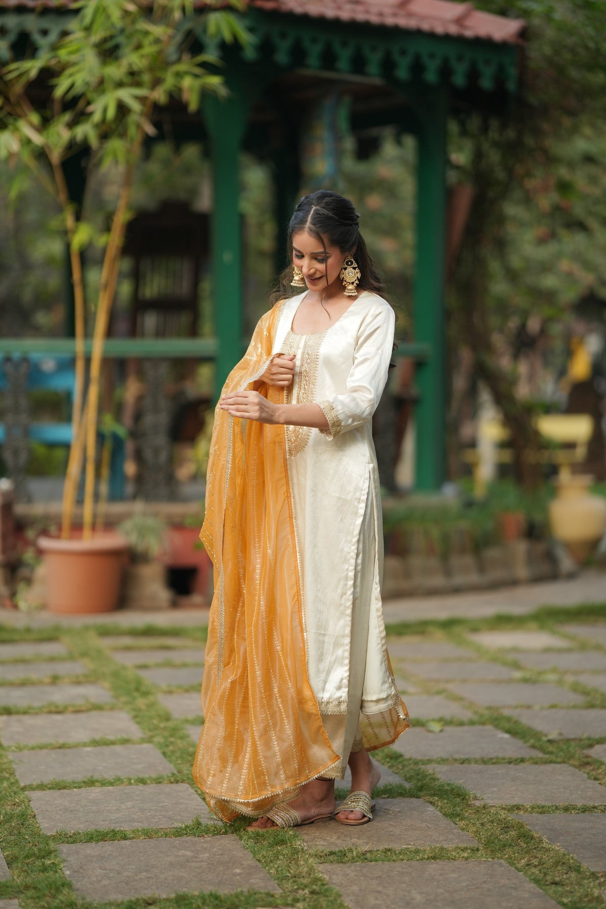 ARTISAN'S MOTIF orange colourway with gold lace hem borders on the off white silk kurta.
