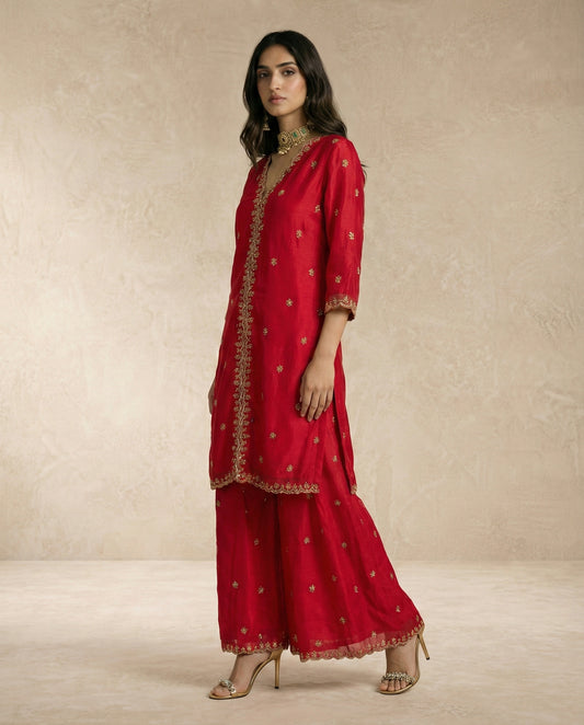 NAZRA red tissue silk kurta and sharara with gold butis and scalloped embroidered hems.