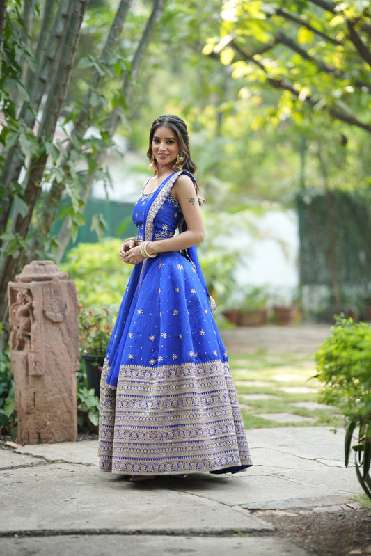 Crop top blouse paired with blue wedding lehenga featuring embroidery