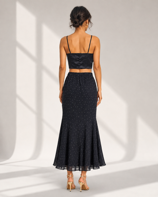 Back view of the FIAMMETTA black cami top showing the clean fitted back and spaghetti straps.