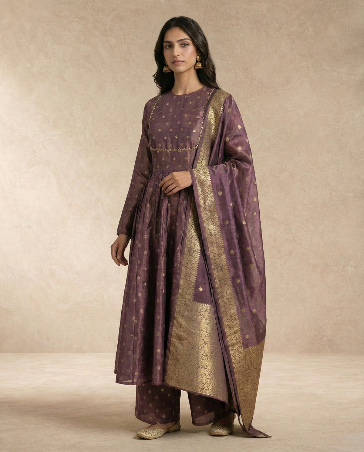 ANAYA mauve banarasi silk anarkali with gold-and-pearl trimmed yoke by Neha Sharma Label.