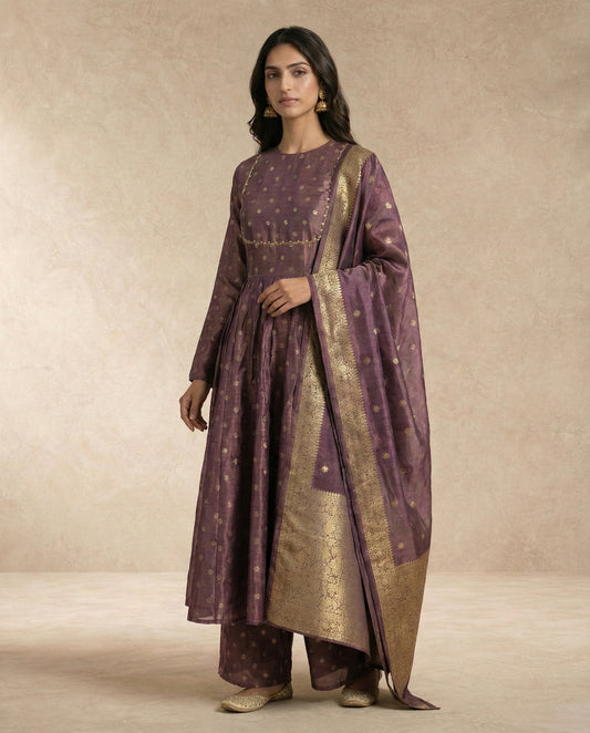 ANAYA mauve banarasi silk anarkali with gold-and-pearl trimmed yoke by Neha Sharma Label.