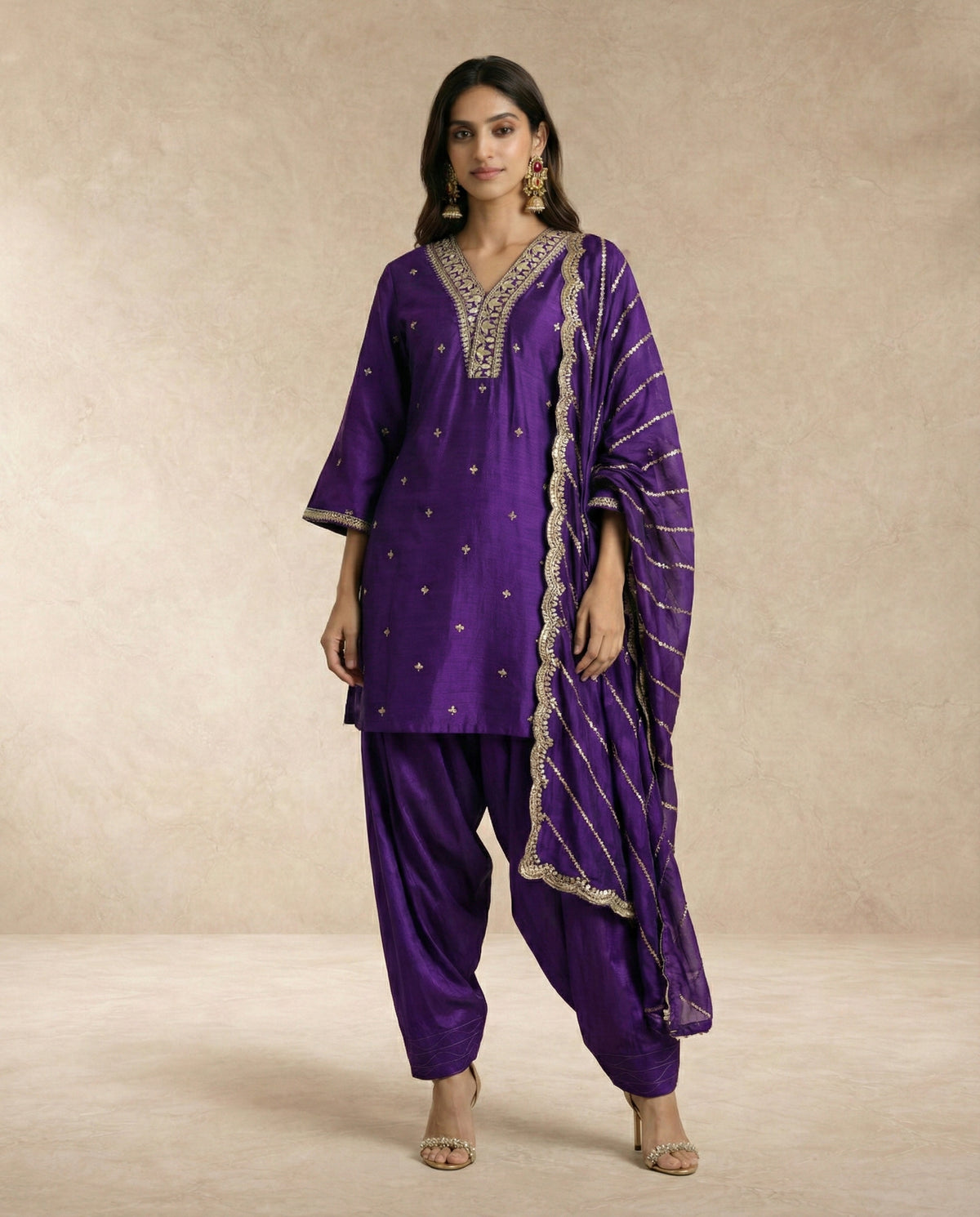 Neha Sharma Label BANAFSHA purple silk kurta salwar set with gold embroidered neckline.