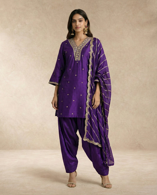 Neha Sharma Label BANAFSHA purple silk kurta salwar set with gold embroidered neckline.