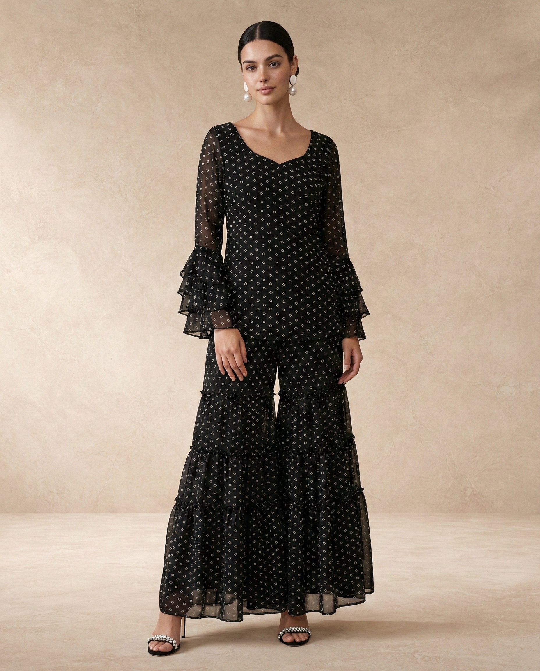 RUKSAR black bandhani kurta and tiered sharara with triple-tier ruffle sleeves.