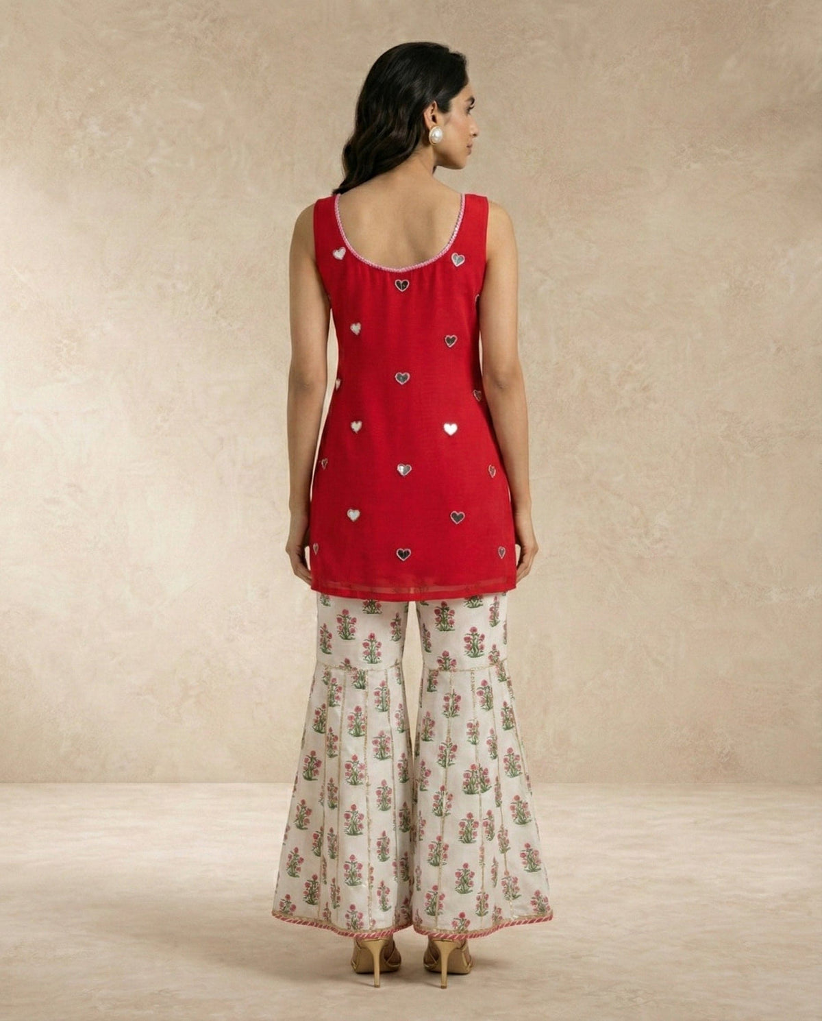 SANA red mirror work gharara set with embroidered sweetheart neckline.