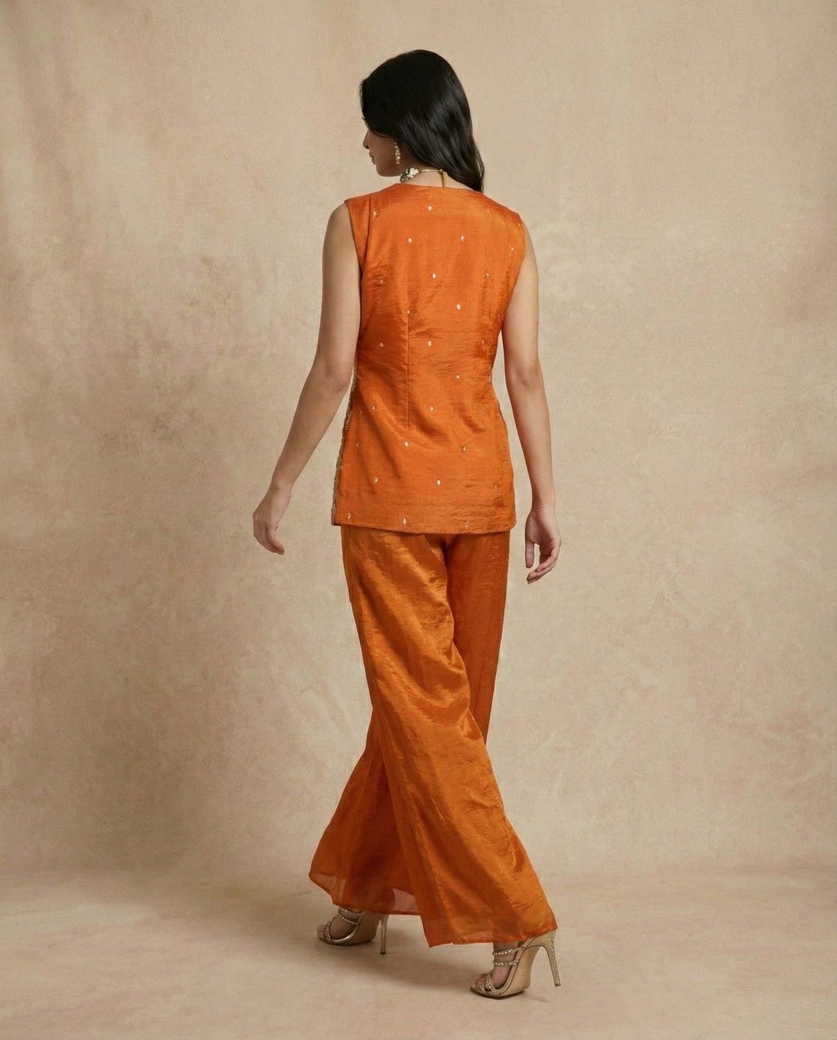 Side view of the SHAHNAZ rust silk embroidered top showing the paisley side medallion by Neha Sharma Label.