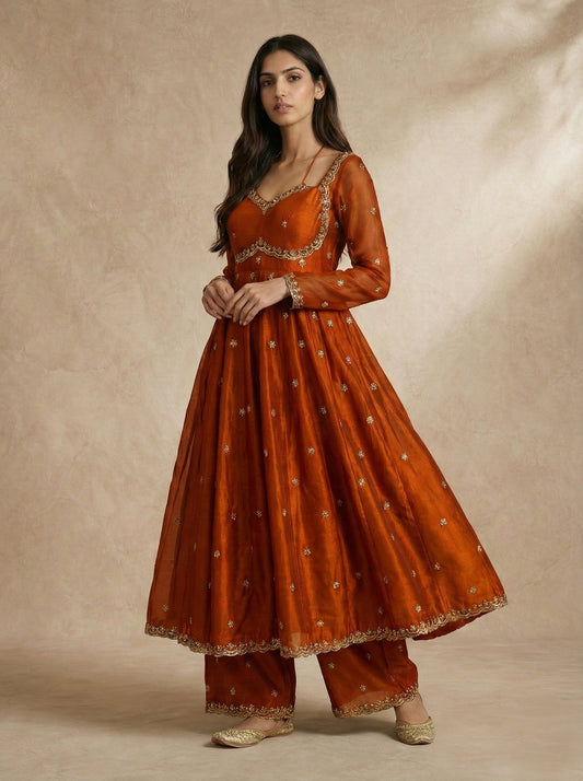 Neha Sharma Label MEHRIN rust silk organza anarkali set with scalloped gold borders.