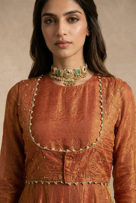 AMAIRA terracotta anarkali with pearl-edged sleeveless jacket by Neha Sharma Label.