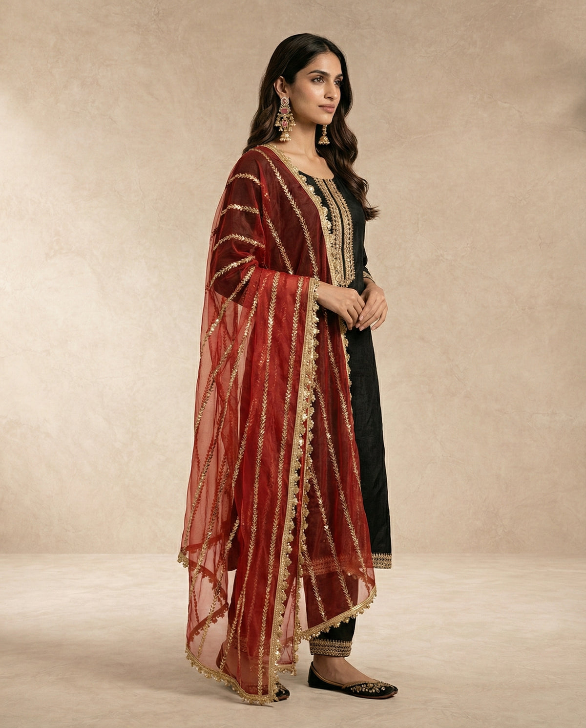 Neha Sharma Label NOORI black raw silk kurta set with a red tissue silk dupatta.