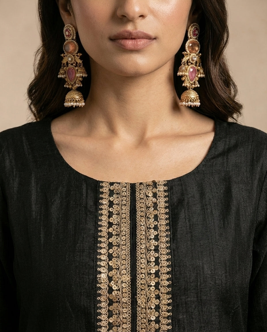 Close view of the NOORI round neckline and the gold toned centre placket on black silk.