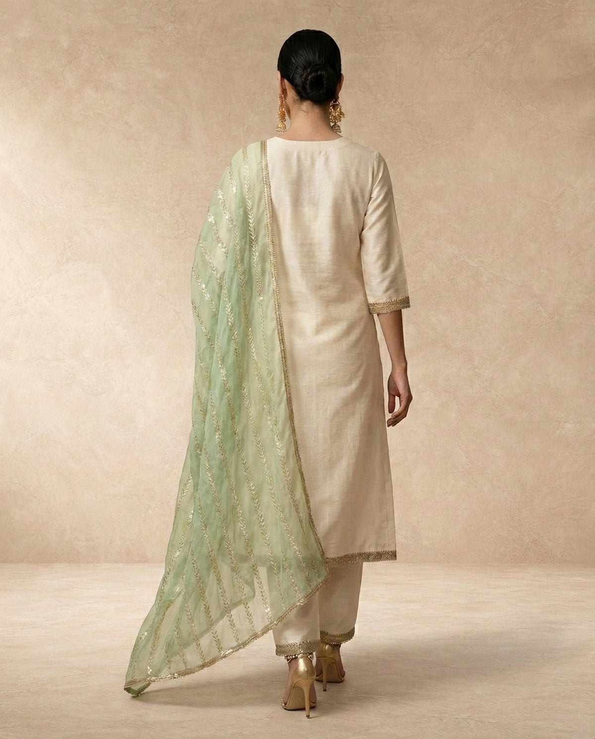 AFREEN ivory banarasi silk kurta set with gold lace borders and straight pants by Neha Sharma Label.