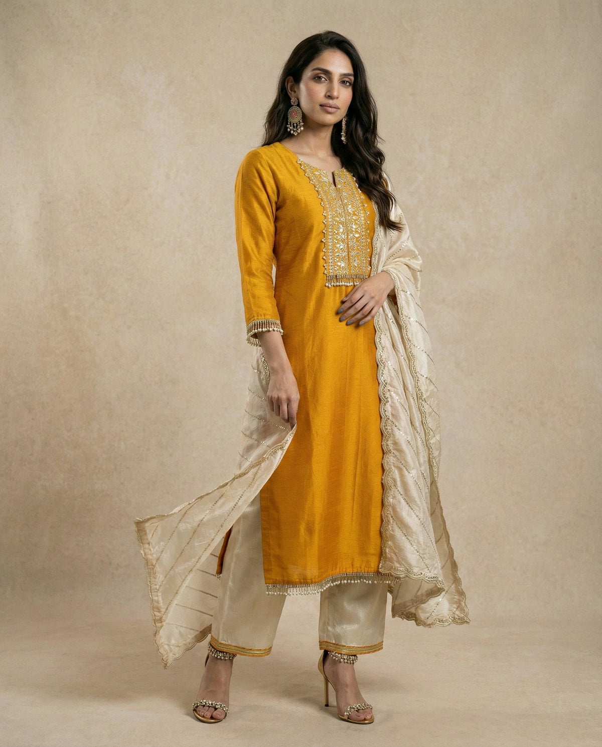 Model wearing HINA mustard gold silk kurta with striped organza dupatta by Neha Sharma Label, front view.