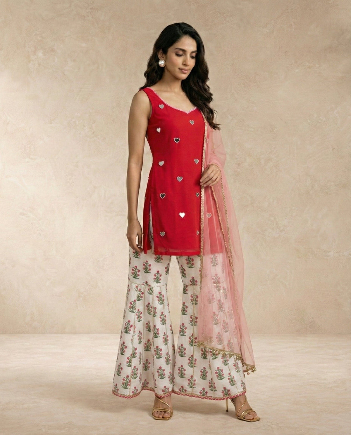 Neha Sharma Label SANA red mirror work kurti with floral printed gharara and sheer pink dupatta.