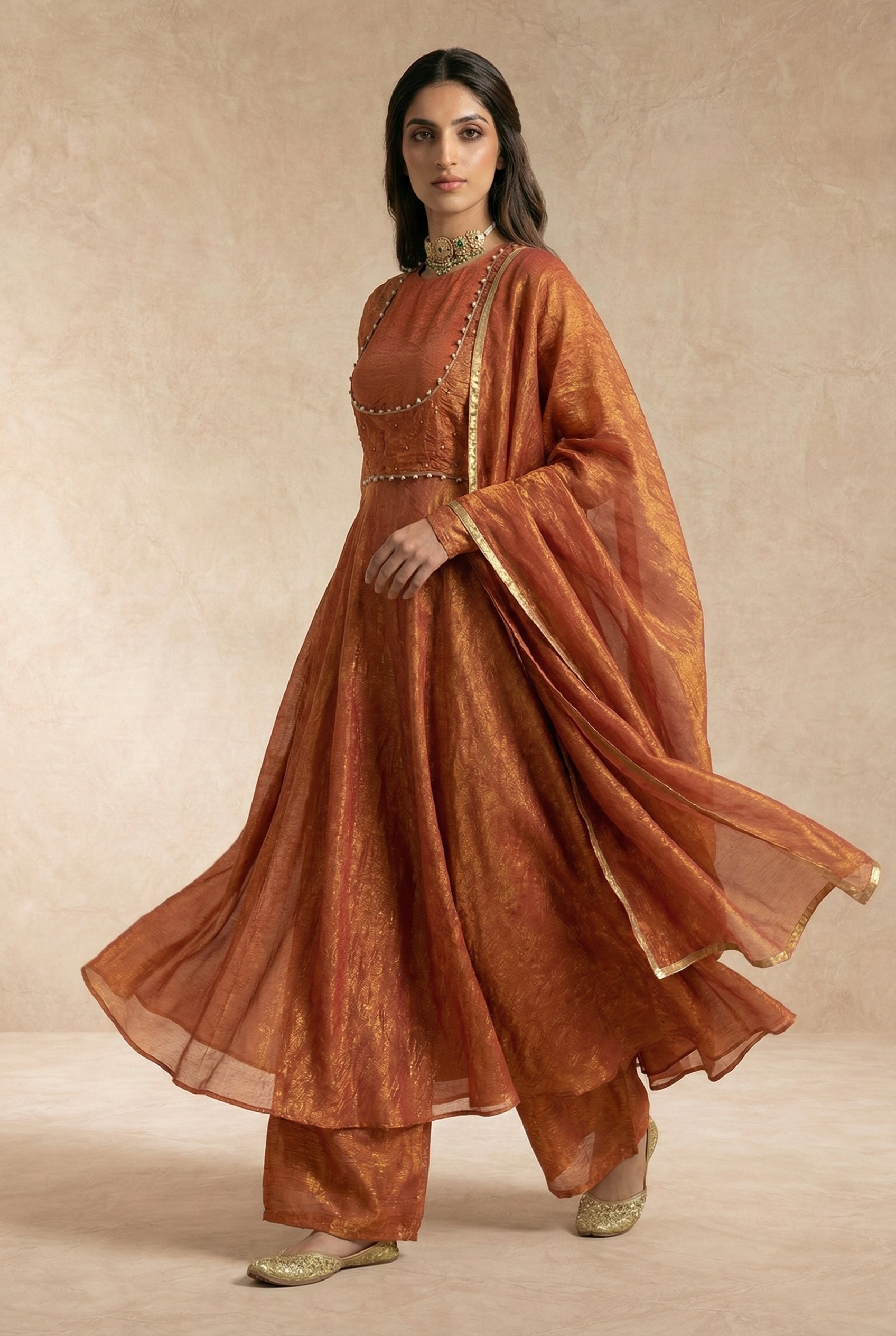 Luminous crushed silk sheen on the AMAIRA terracotta anarkali by Neha Sharma Label.