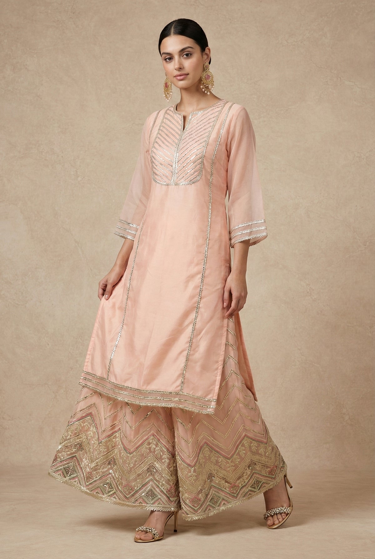 Side view of ZEENAT showing the kurta slit and chevron gota embroidery running down the sharara.
