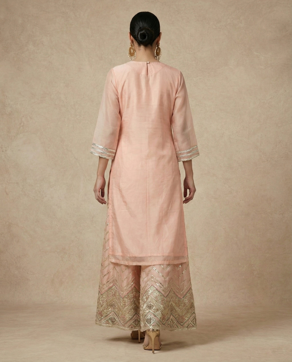 Close view of ZEENAT's mitred chevron yoke in silver sequin and gota-line embroidery.