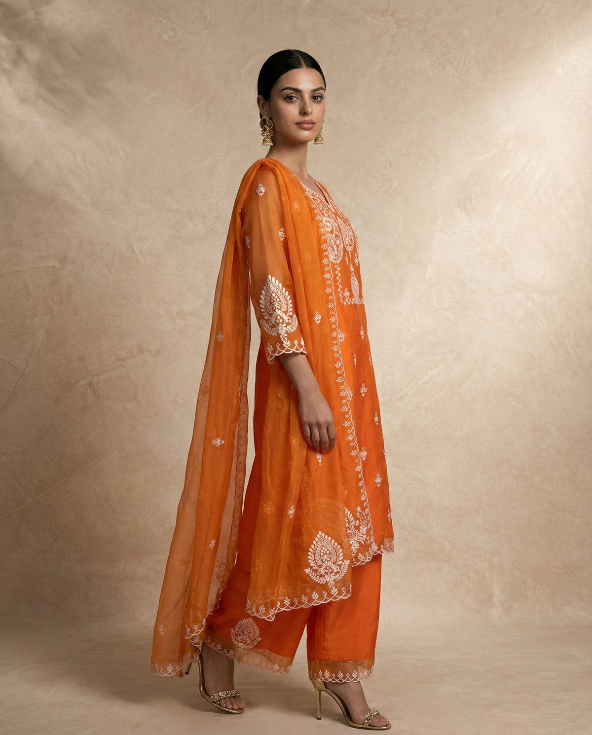 IFRA orange organza kurta set with embroidered palazzo hems by Neha Sharma Label.