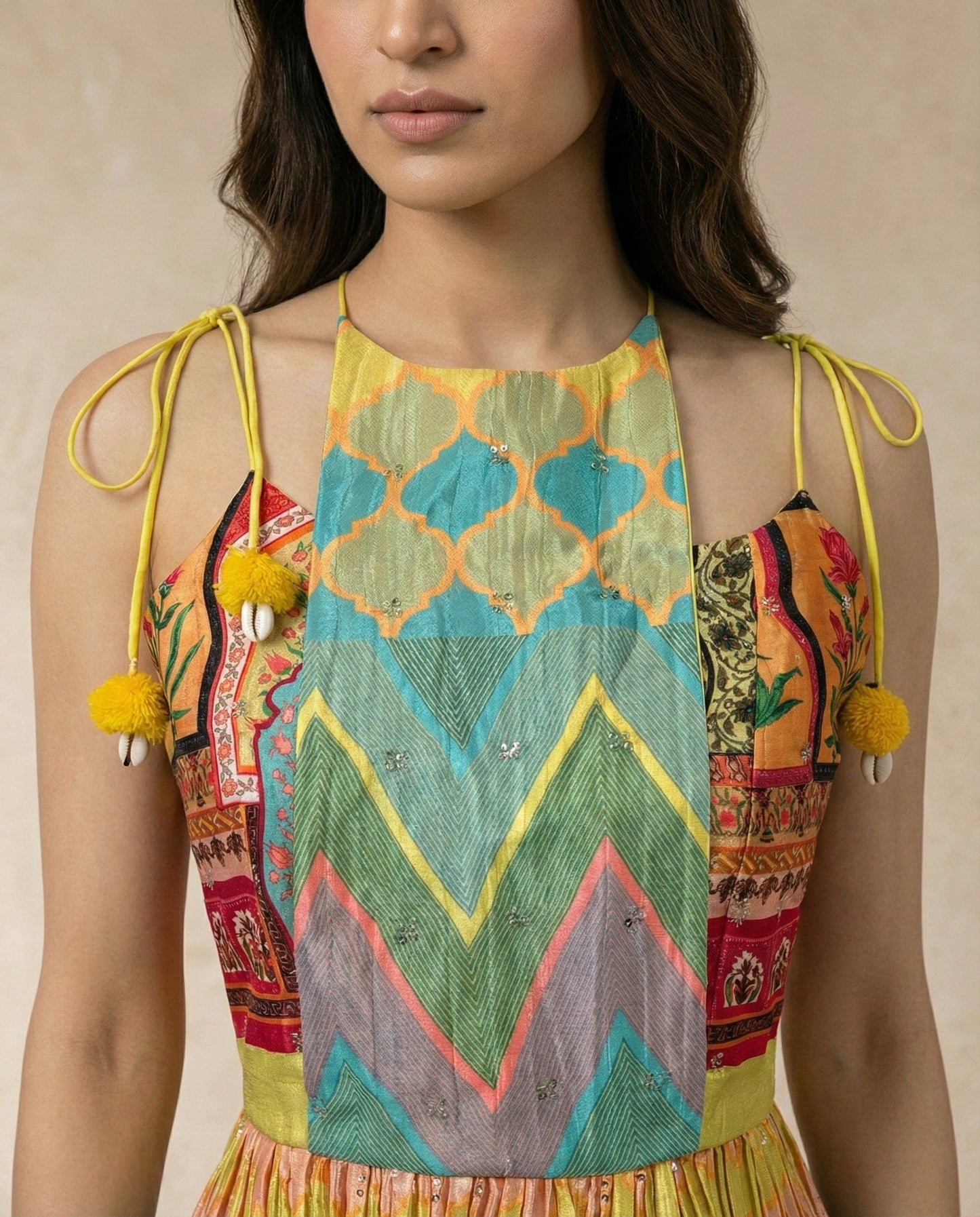 Close view of the SAFI bodice with its ogee and chevron centre panel and cowrie shells.