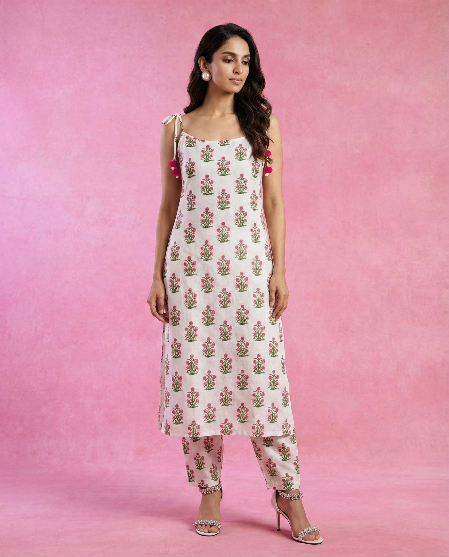 Neha Sharma Label HOOR white cotton kurta set with pink floral print and tie-up shoulder straps.