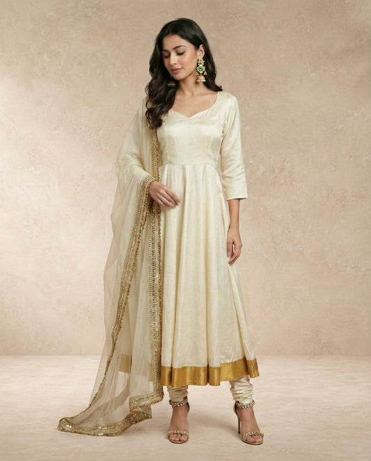 Neha Sharma Label ANJUM ivory pure silk anarkali set with churidar and sheer gold-bordered organza dupatta.