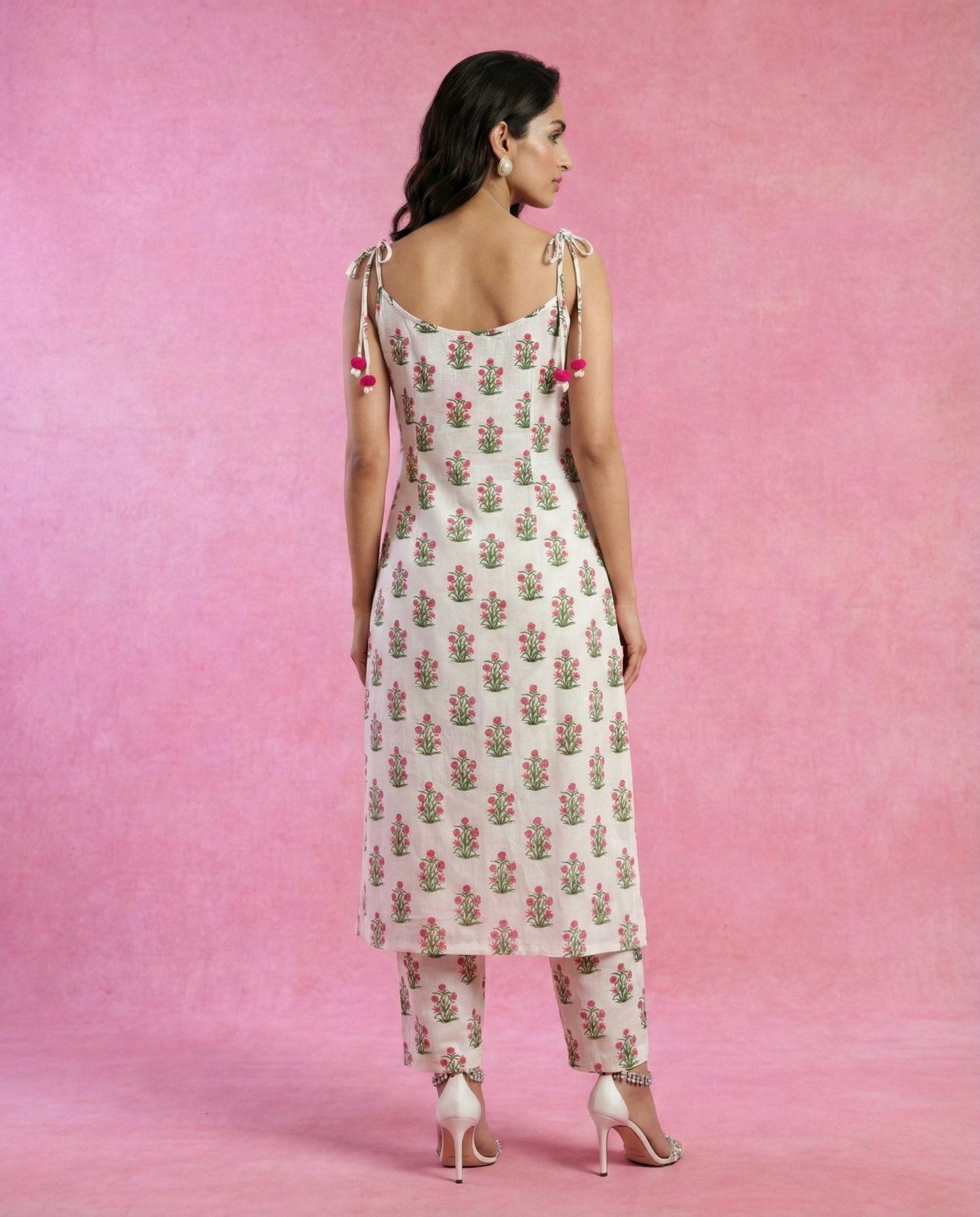 HOOR white cotton kurta with tie-up straps and pom-pom tassels by Neha Sharma Label.