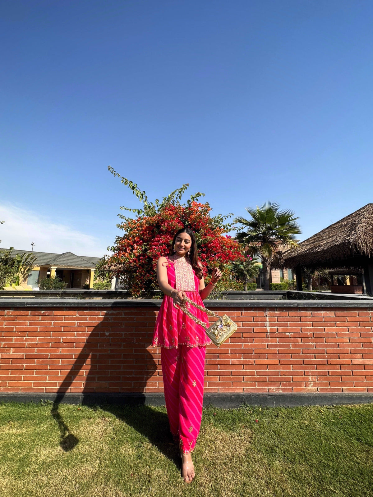 Fuchsia Flare rani pink leheriya flap kurta set with embroidered yoke and mirror-accented scalloped hem.