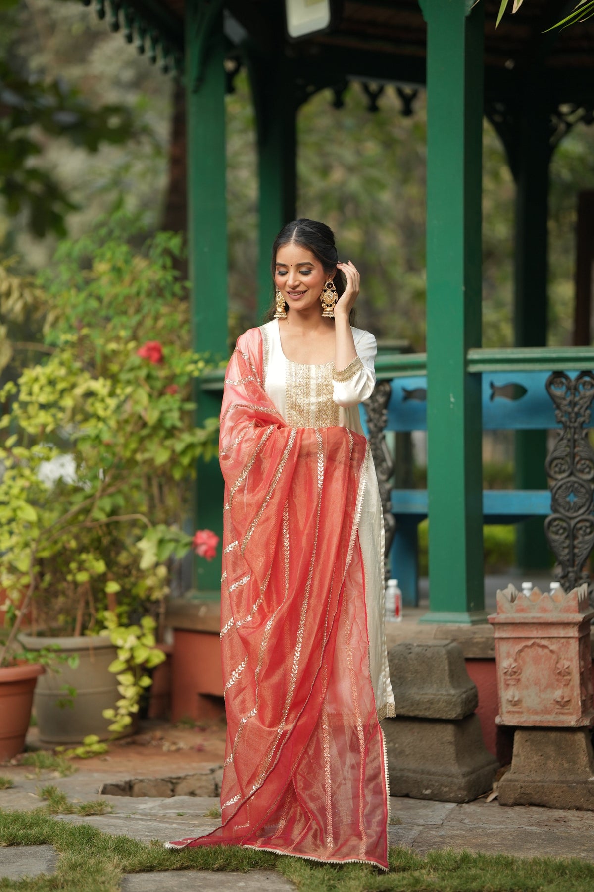 The vermilion tissue dupatta with its diagonal gold embroidery and scalloped lace edge.