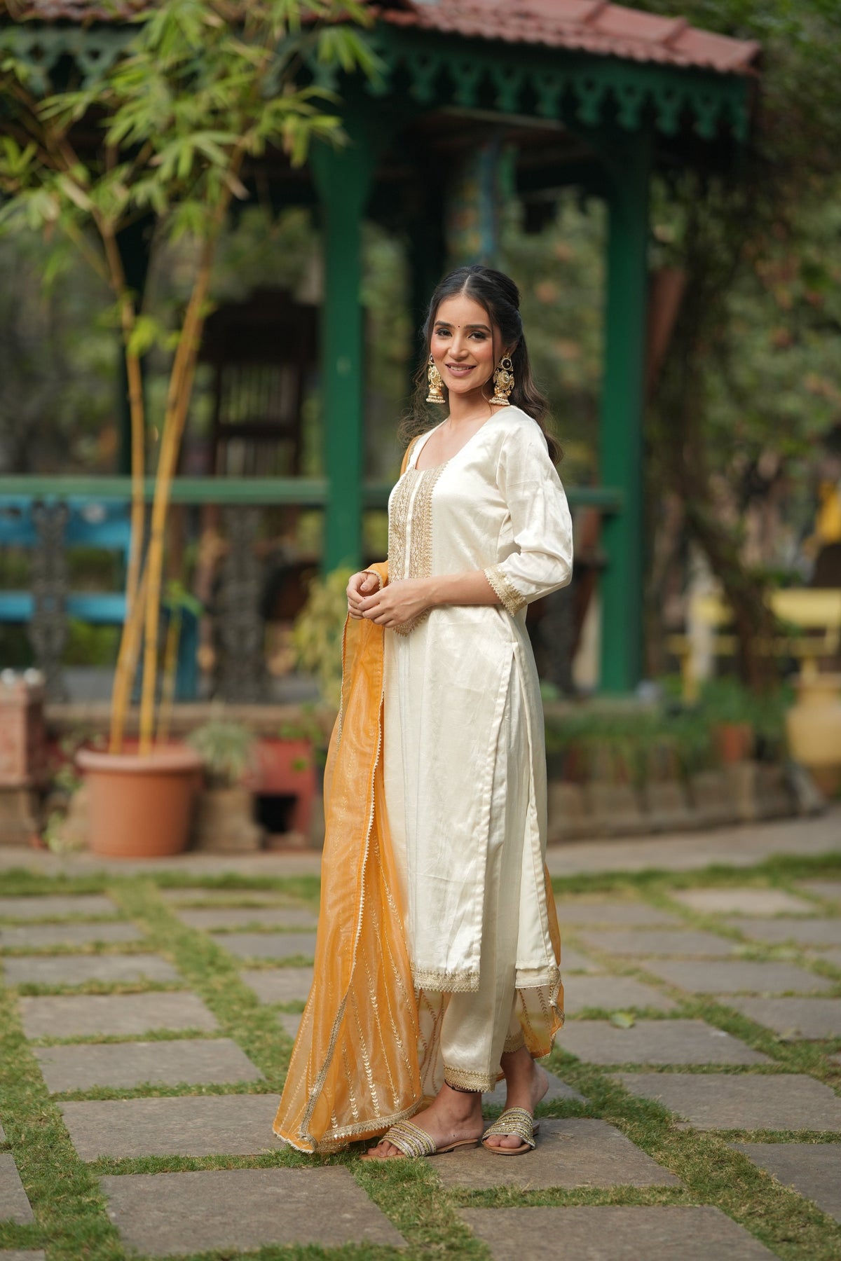 ARTISAN'S MOTIF off white silk kurta set shown with the sheer orange tissue dupatta.