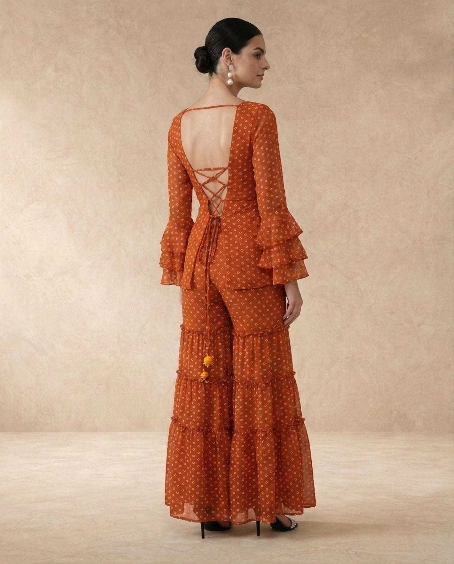 AMBER rust bandhani print sharara set styled with the matching dupatta.