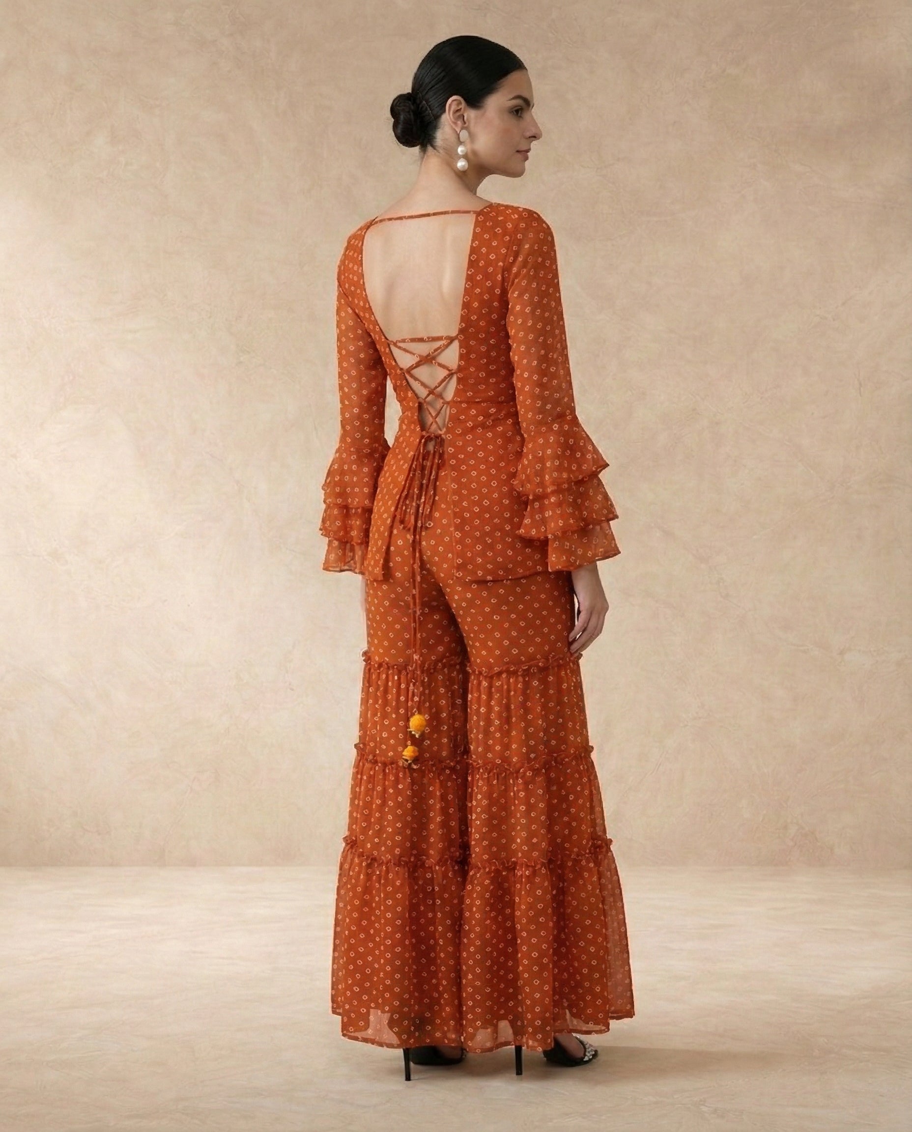 AMBER rust bandhani print sharara set styled with the matching dupatta.