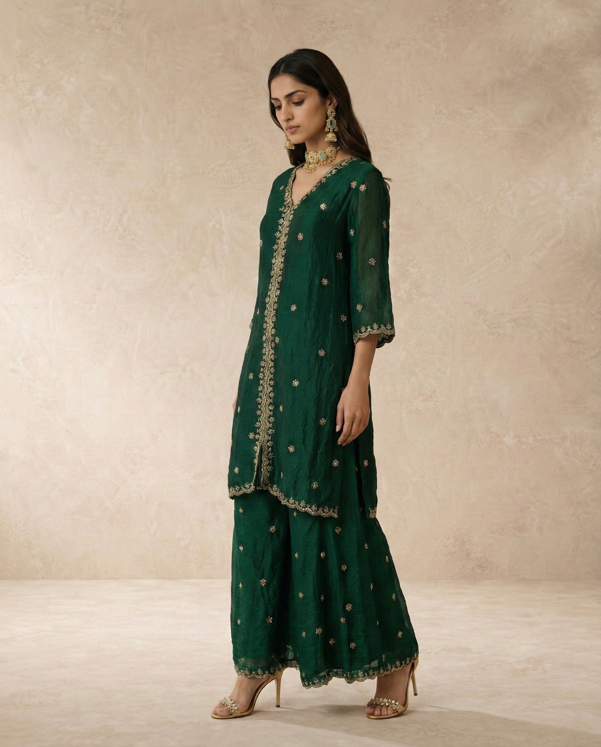 Ferdos emerald tissue silk sharara set, full-length view with gold scalloped borders.