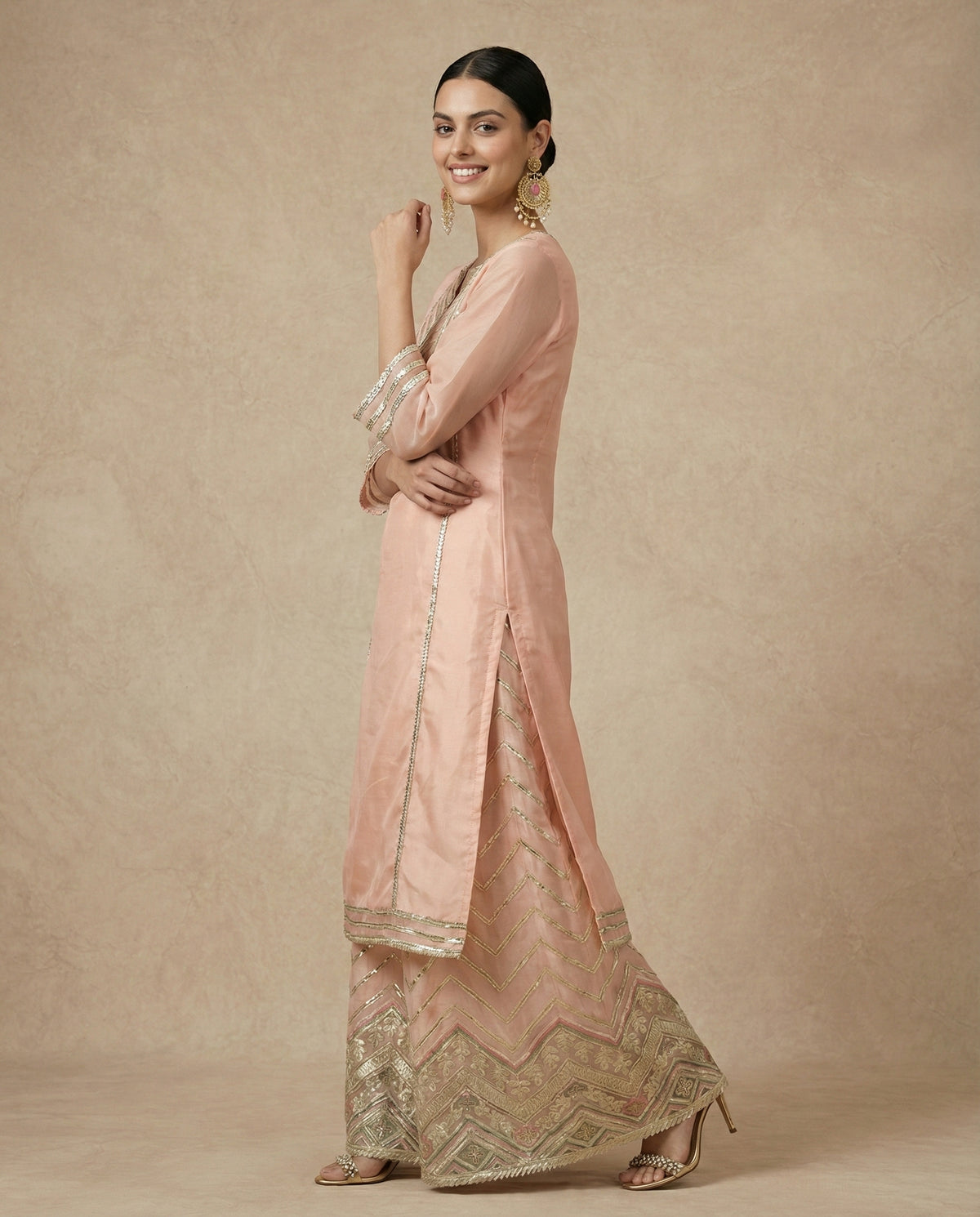 ZEENAT peach kurta and full-flare chevron-embroidered sharara, front view without the dupatta.