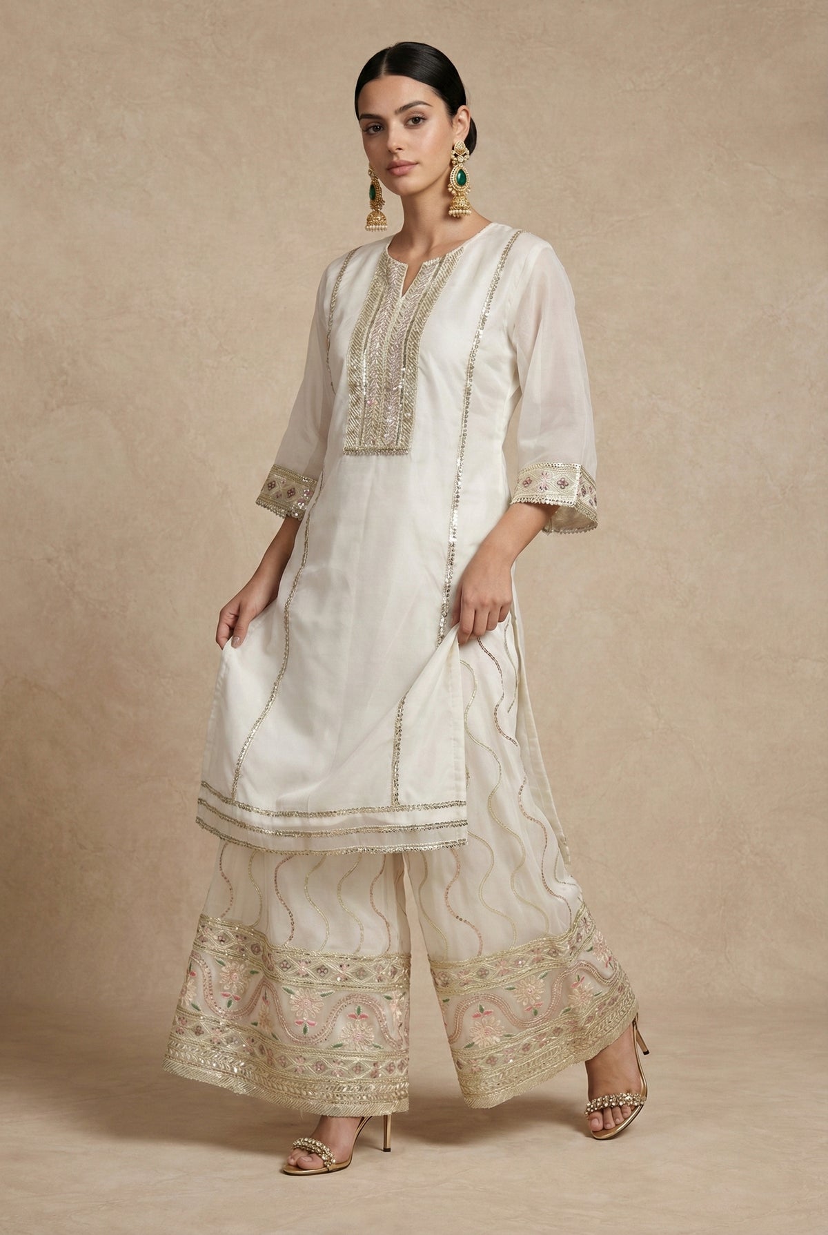 KISHWAR ivory organza sharara set worn with the dupatta draped over one shoulder, full-length front view.