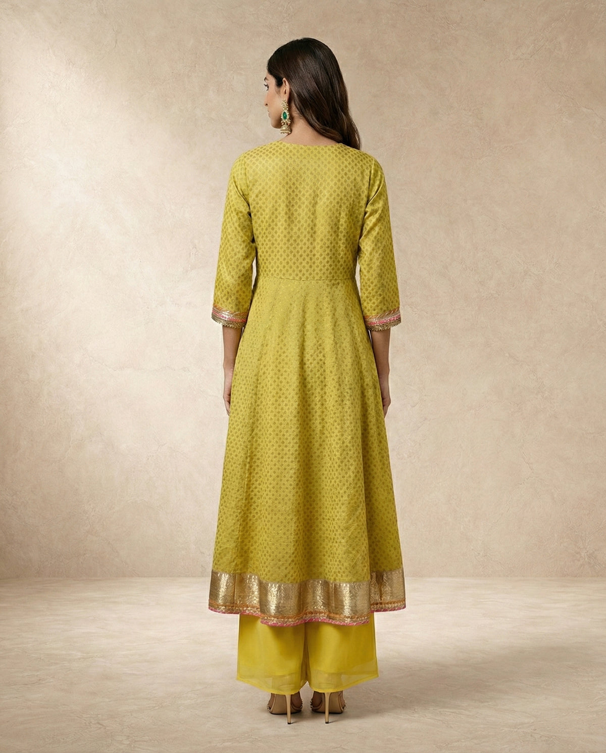 NAZAKAT mustard anarkali with tie-up yoke, pom-poms and cowrie shells by Neha Sharma Label.