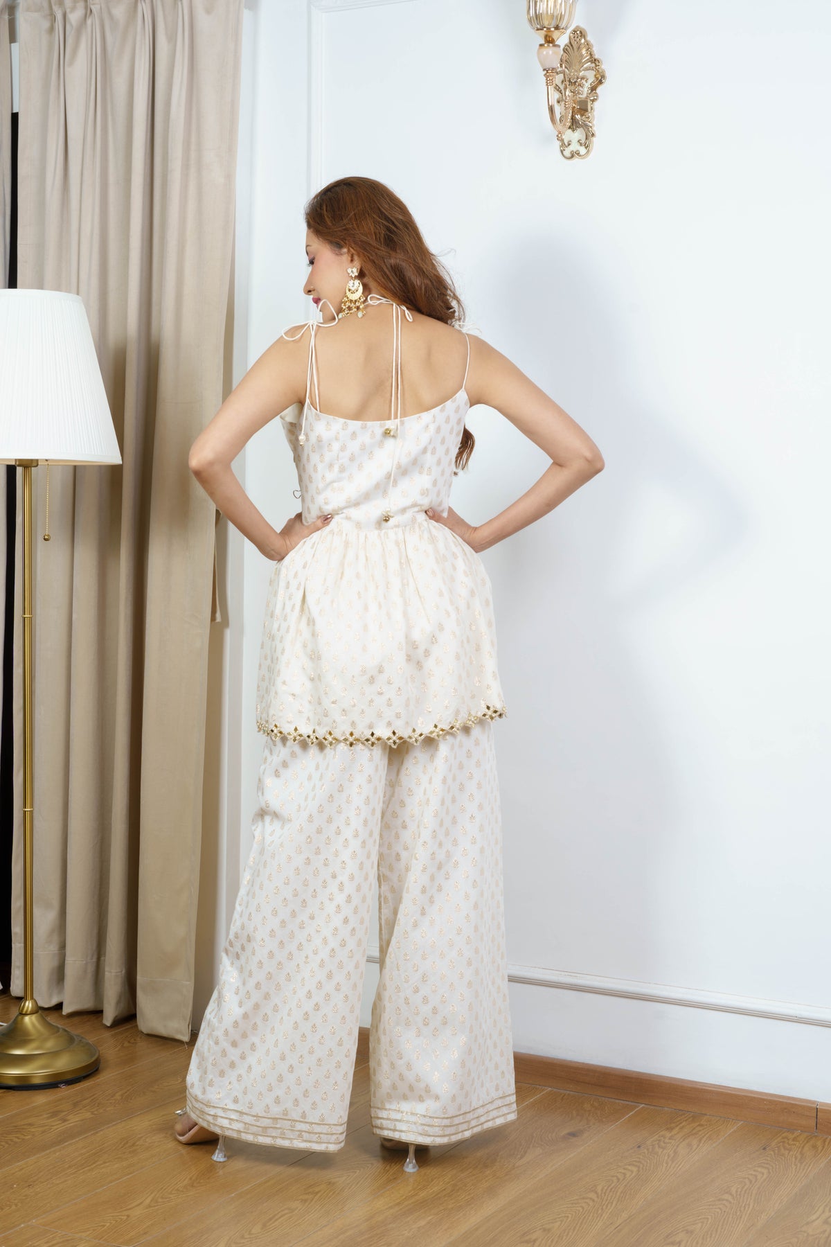 GAUHAR ivory peplum kurta with double tie-up bead-end straps by Neha Sharma Label.