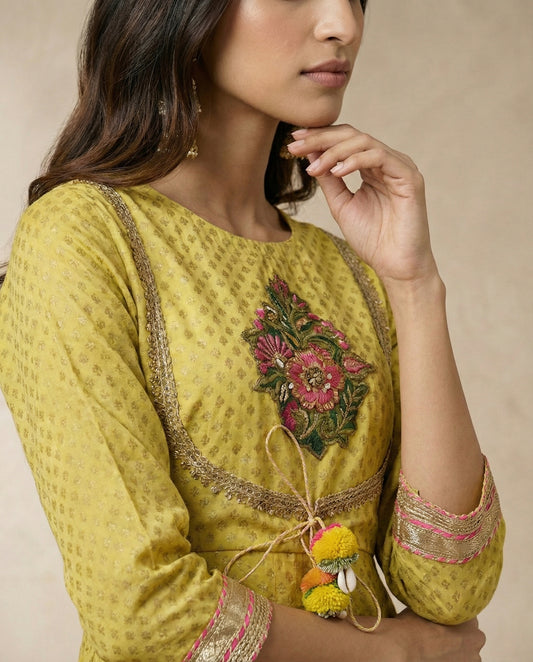 NAZAKAT mustard anarkali with gota-trimmed yoke and embroidered floral bouquet by Neha Sharma Label.