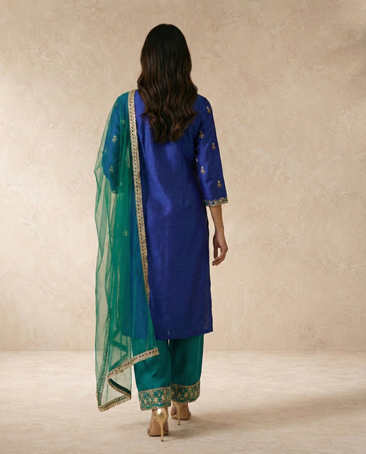 FIROZA royal blue kurta with hand-embroidered gold yoke and teal net dupatta by Neha Sharma Label.