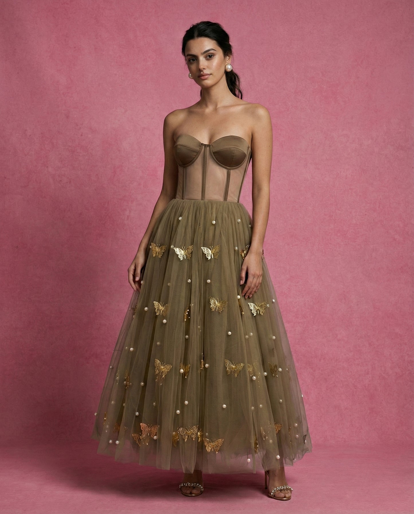 Close-up of SOREN's olive tulle skirt with signature gold metal butterflies and pearl beads
