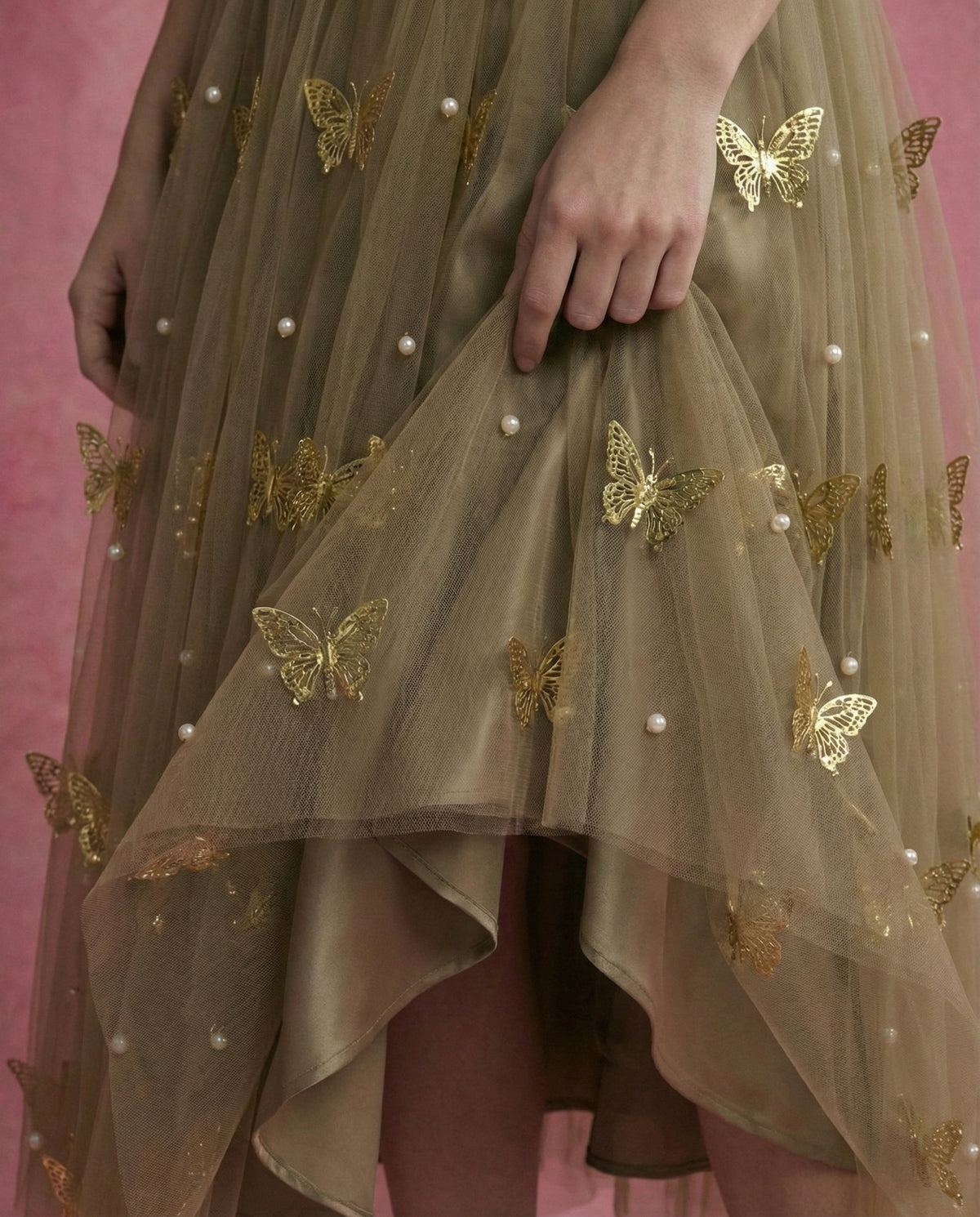 SOREN olive gown, full-length view showing layered tulle skirt with metal butterflies and pearl detailing