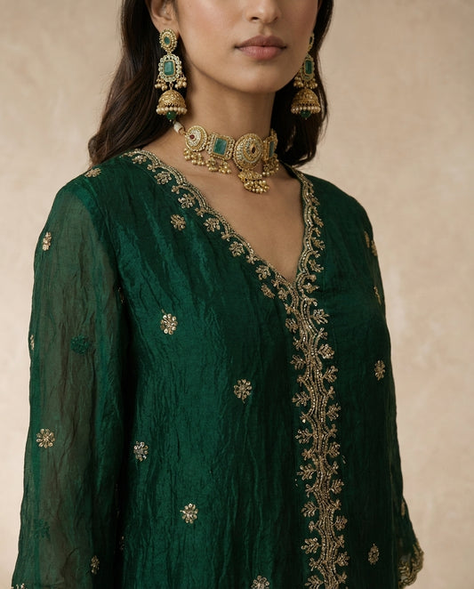 Ferdos emerald tissue silk kurta and sharara with gold butis and scalloped embroidered hems.