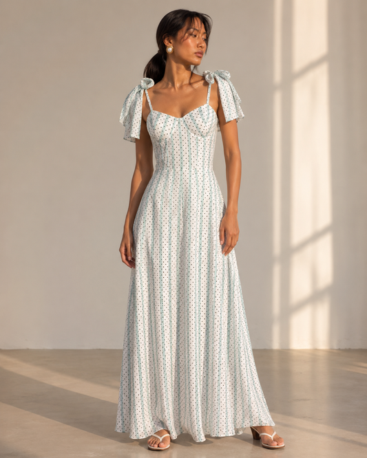 Model wearing SYLVIE white corset maxi dress with mint stripes and black dots by Neha Sharma Label.
