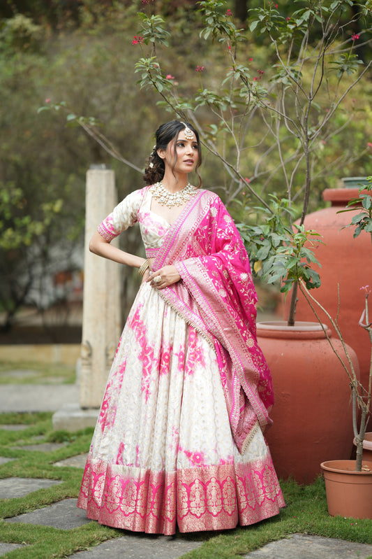 Front view of designer Banarasi silk lehenga for wedding with pink-white tie-dye and zari border ? perfect bridal and party wear ensemble.