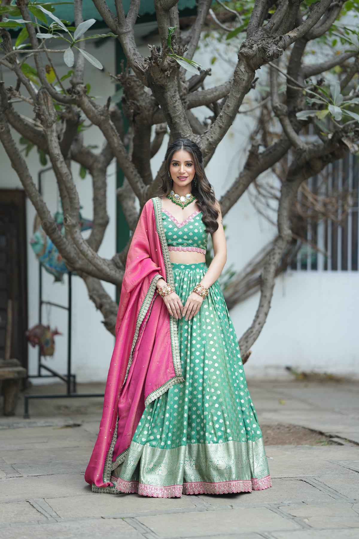 golden zari buti work on the Emerald Opulence Green Banarasi Lehenga