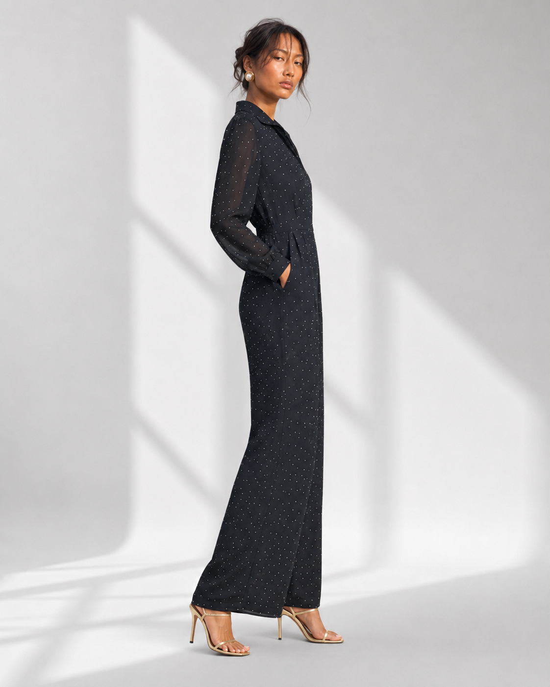 SEVERINE navy micro dot jumpsuit in profile with wide legs and sheer full sleeves.