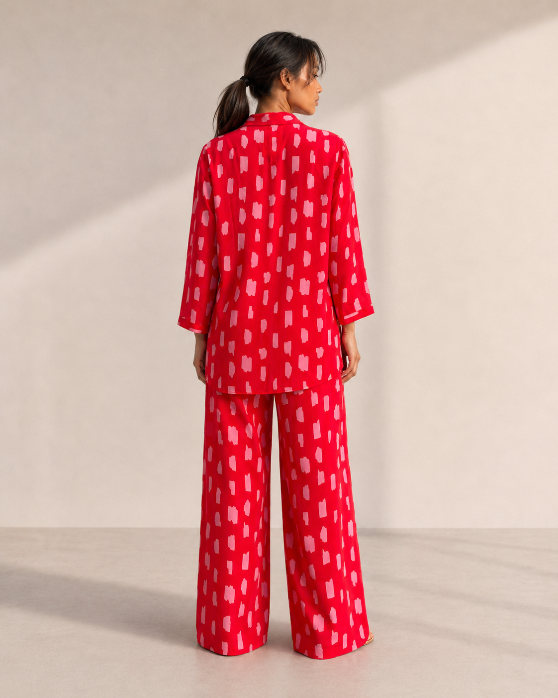 SCARLETT wide-leg trousers in the red brushstroke print, worn with the matching shirt.