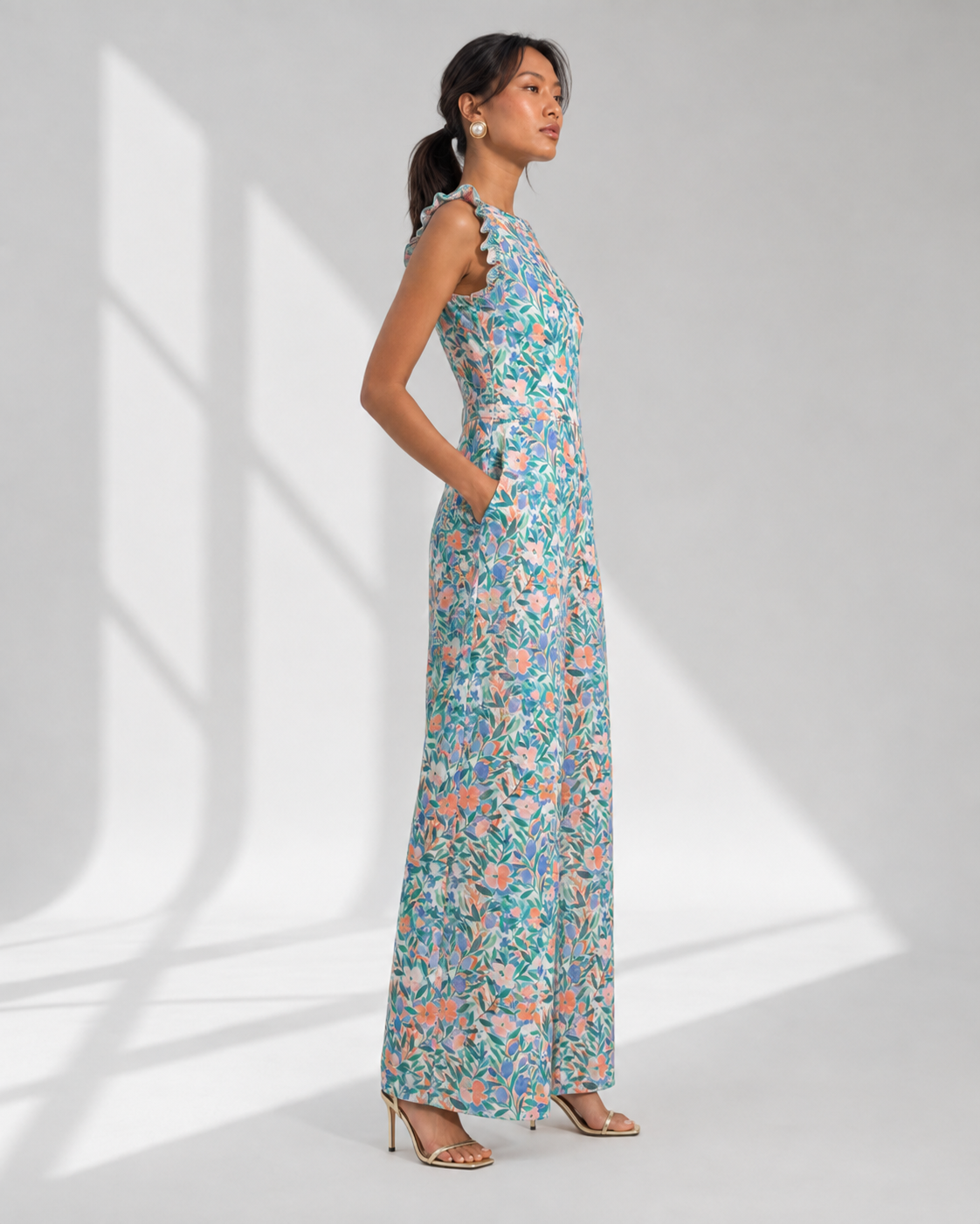 FLEUR white garden floral wide-leg jumpsuit in profile with side-seam pockets.