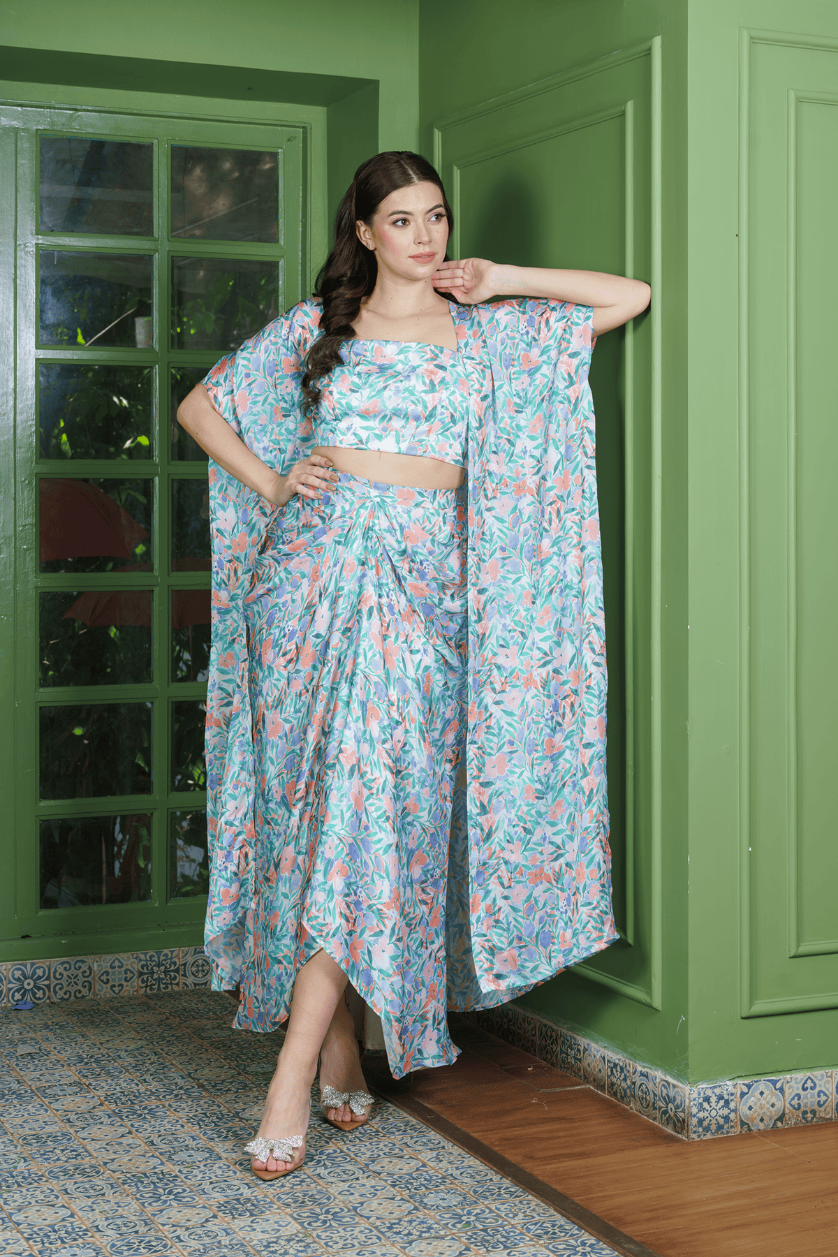 Model wearing leafy print dhoti set for women with crop top and long jacket ?perfect indo western outfit for festive and wedding occasions.