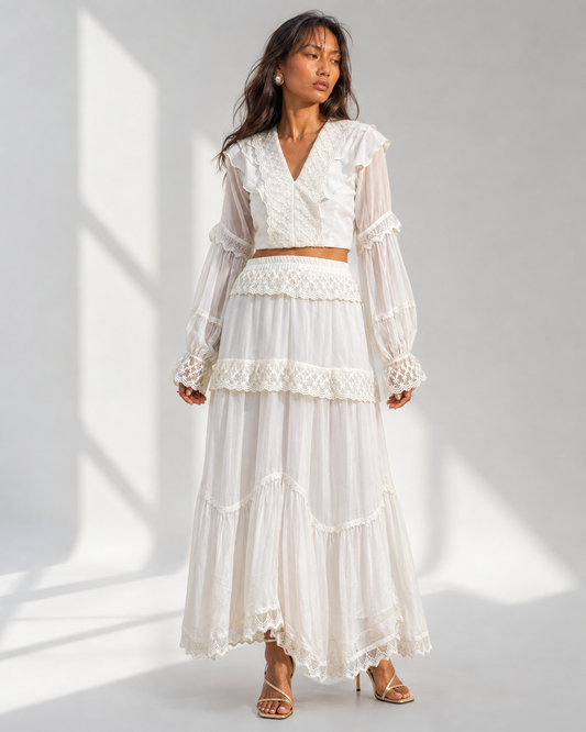 Neha Sharma Label MORWENNA ivory lace trim crop top worn with the matching tiered skirt, front view.
